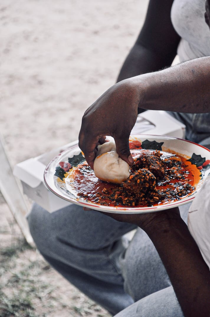 A guest enjoying a plate of local food at MedFest
